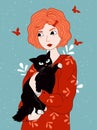 Redheaded girl holding black cat