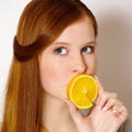Redheaded girl with orange Royalty Free Stock Photo