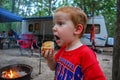 Redhead Boy Camping Getting Ready to Eat a Large Roasted Marshmallow