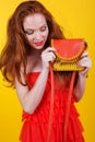 Redheaded smiling girl with orange purse Royalty Free Stock Photo