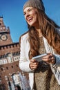 Smiling young traveller woman in Milan, Italy writing sms Royalty Free Stock Photo
