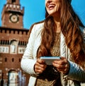 Smiling young woman in Milan, Italy writing sms Royalty Free Stock Photo