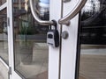 Redmond, WA USA - circa March 2021: Close up view of a Master Lock padlock on large, glass doors Royalty Free Stock Photo