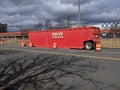 Redmond, WA USA - circa March 2021: View of a large, red Adler Tank rental in downtown Redmond on an overcast day