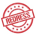 REDRESS text written on red vintage stamp