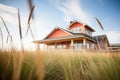 redroofed prairie house with wide eaves, amidst tall grass Royalty Free Stock Photo