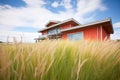 redroofed prairie house with wide eaves, amidst tall grass