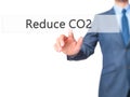 Reduce CO2 - Businessman hand pressing button on touch screen in Royalty Free Stock Photo