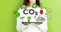 Reduce CO2 with woman holding a tablet