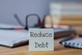 Reduce Debt business text written on wooden chips. Royalty Free Stock Photo