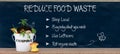 Reduce food waste text, ways to reduced food waste listed on chalk board with compost bin