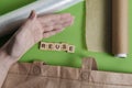 reduce, reuse and recycle word in vintage wooden letterpress type blocks, flatlay on green font Royalty Free Stock Photo