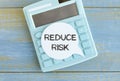 Reduce Risk text on white paper on calculator Royalty Free Stock Photo
