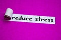 Reduce Stress text, Inspiration, Motivation and business concept on purple torn paper