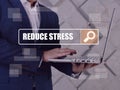 REDUCE STRESS text in search bar. Loan officer looking for something at laptop