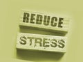 Reduce Stress text on wooden blocks on vivid pink. Calm relax health concept