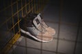 Reebok GL 6000 Mid sneakers in brown color outdoor on dark industrial background. Krasnoyarsk, Russia - January 10, 2018