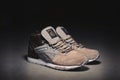 Reebok GL 6000 Mid sneakers in brown grey color shot outdoor on dark background. Krasnoyarsk, Russia - January 10, 2018