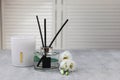 Reed diffuser, scented candle and eustoma flowers on gray marble table, space for text Royalty Free Stock Photo