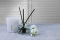 Reed diffuser, scented candle and eustoma flowers on gray marble table, space for text Royalty Free Stock Photo