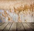 Reed and empty wooden deck table.