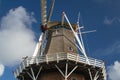 Reed hood or classical windmill against blue sky with clouds