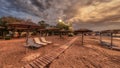 Reed parasols on beach under cloudy sky