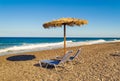 Two sunbeds Black beach Kamari village Santorini Greece Royalty Free Stock Photo