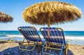 Two sunbeds Black beach Kamari village Santorini Greece Royalty Free Stock Photo