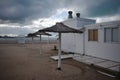 Reed umbrellas on empty beach during quarantine in Mar del Plata. Coastline with temporarily out of service tourist infrastructur