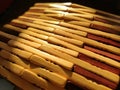Reed or wood mat. The rug is a mat under the hot. Knitted processed wood sticks with rounded edges. Close-up. Yellow, brown and Royalty Free Stock Photo