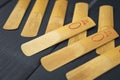 Reeds for a mouthpiece of a wooden instrument on gray wooden background Royalty Free Stock Photo