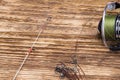 Reel with fishing line from fishing pole lies on a wooden burnt background Royalty Free Stock Photo