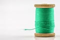 Reel or spool of green sewing thread on white. Shallow Royalty Free Stock Photo