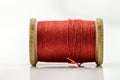 Reel or spool of red sewing thread isolated on white. Shallow de Royalty Free Stock Photo
