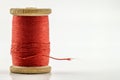 Reel or spool of red sewing thread isolated on white. Shallow de Royalty Free Stock Photo