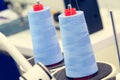 Reels of textile yarn blue thread at industrial weaving manufacturing machine Royalty Free Stock Photo