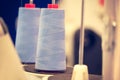 Reels of textile yarn blue thread at industrial weaving manufacturing machine Royalty Free Stock Photo