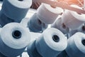 Reels of textile yarn blue thread at industrial weaving manufacturing machine Royalty Free Stock Photo