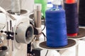 Reels of textile yarn blue thread at industrial weaving manufacturing machine Royalty Free Stock Photo