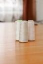 Reels with white threads for a sewing machine in atelier Royalty Free Stock Photo