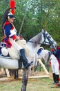 Reenactor-cuirassier dressed as Napoleonic war soldier rides a horse.