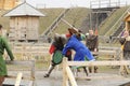 Reenactors dressed in armor of Old Russian footmen reconstructing swords fight