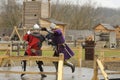 Reenactors dressed in armor of Old Russian footmen reconstructing swords fight