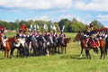 Reenactors dressed as Napoleonic war French soldiers ride horses Royalty Free Stock Photo