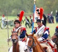 Reenactors dressed as Napoleonic war French soldiers ride horses