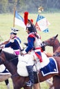 Reenactors dressed as Napoleonic war French soldiers ride horses