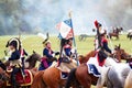 Reenactors dressed as Napoleonic war French soldiers ride horses