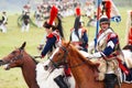 Reenactors dressed as Napoleonic war French soldiers ride horses Royalty Free Stock Photo