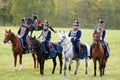 Reenactors dressed as Napoleonic war Russian soldiers ride horses Royalty Free Stock Photo